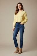 Studio model wearing yellow sweater